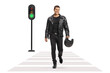 © Ljupco Smokovski - Man in leather jacket holding a motorbike helmet and crossing a street