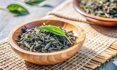 Wall Mural - there is fresh black dry tea in a cup on the table