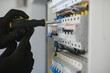 © Serhii - Close-up of electrician working on circuitry