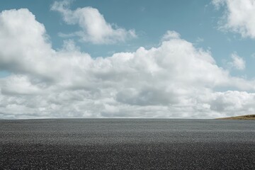 Wall Mural - Asphalt road under a cloudy sky.