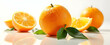 © chaiyadid - Vibrant oranges, glistening with juice, rest on a bright surface, accompanied by fresh green leaves. A burst of citrus freshness!