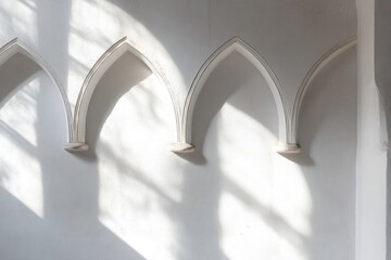 Poster - A minimalist wall featuring three pointed arches casting shadows.