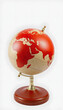 © Go - Red earth globe isolated on white background, vintage