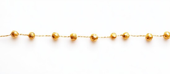 Wall Mural - golden bead garland thread elegantly displayed on a clean white background showcasing festive decora