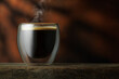 © alter_photo - espresso in glass cup on table with brown background