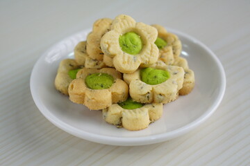 Indonesian mint cookies photographed on a white table with a wooden theme in an indoor studio