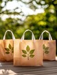 © Arnon  Parnnao - Eco-friendly bags with leaf design placed in a natural outdoor setting.