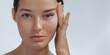 © Buyanskyy Production - Close-up of a young woman with smooth, glowing skin touching her face in a minimalist portrait. Perfect for skincare, beauty, or wellness campaigns. High-quality image ideal for cosmetic or anti-aging