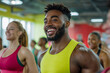 © Karrrtinki - Happy African American Male in Yellow Sportswear Participating in Group Fitness Class at a Modern Gym