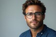 © furyon - stylish portrait of a handsome young brunette man wearing eyeglasses and a blue shirt isolated on a clean white background exuding confidence and intelligence for a professional image