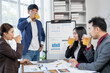 © Wasana - A group of people are drinking tea in a meeting room