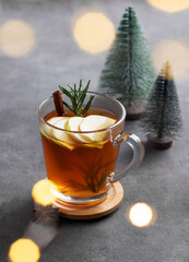 Wall Mural - Homemade apple punch with fresh apples, cinnamon and rosemary in a cup on a dark background