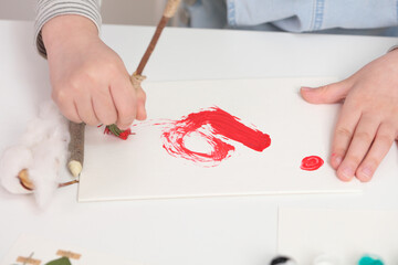 a child drawing a red pattern