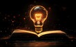 © Itsaree  - A bright light bulb floating above an open book, representing the flow of ideas and inspiration, set in a dark atmosphere with a touch of warm glow