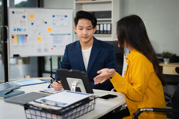 Wall Mural - Asian business people discussing on performance revenue in meeting. businessman working with co-worker team. financial adviser analysing data with investor.