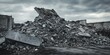 © Rufat - Concrete fragments of construction debris are piled up against the backdrop of building remnants and a cloudy gray sky, creating a striking scene of construction debris and its aftermath.
