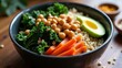 © yarku20 - A vibrant and healthy vegetarian bowl brimming with chickpeas, kale, carrots, avocado, and couscous. A delicious and nutritious meal.