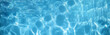 © RM Graphics - Blue clear water surface texture with ripples, splashes and bubbles. Abstract summer banner background Water waves in sunlight
