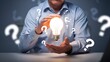 © mod - Businessman Holding Glowing Light Bulb with Question Marks, Creative Thinking, Problem Solving, Solution Concept, Innovation Idea