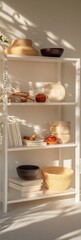 Poster - Sunlit white shelving unit with bowls, books, and decorative objects.