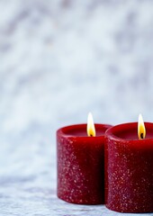 Canvas Print - Two red candles burning on marble.