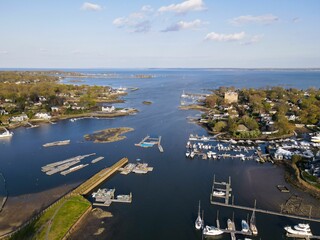 Wall Mural - Aerial view of coastal town with marinas and boats.