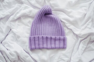 Wall Mural - Cozy purple knitted beanie on white background