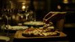 © Sadia - Enjoying a delicious slice of pizza in a dimly lit restaurant setting in the evening