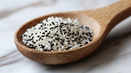 Canvas Print - Raw black and white rice mixture in a wooden spoon on a marble surface showcasing natural textures and ingredients for culinary use