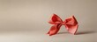 © DigitalDruid - Elegant coral ribbon bow on a soft beige background showcasing simplicity and charm for festive or decorative themes.