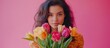 © AbstractAI - Young woman with a vibrant bouquet of multicolored tulips against a soft pink backdrop exuding joy and freshness in a warm setting.