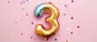 © AbstractAI - Rainbow foil number three balloon on a pink background with sequins ideal for celebration event announcements and decorations