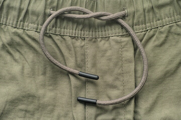 close up shot of shorts with drawstring waistband.