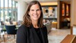 © jaargib - Smiling businesswoman in modern lobby.
