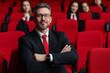 © HEPJAM PHOTO - Confident professional man in suit standing in front of audience in auditorium