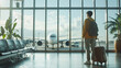 © Paula - Traveler with luggage at airport terminal looking at airplane