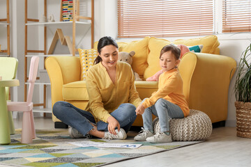 Canvas Print - Female speech therapist with cute little girl pronouncing letters in office