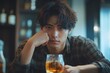 © Infinity Gallery - melancholy young Asian man drinks alcoholic whisky alone at home feeling dizzy after drunk, Generative AI