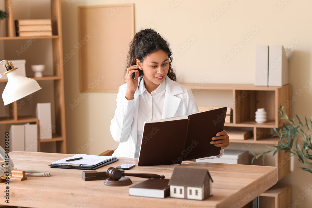 Female African-American lawyer working at table in office