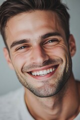 Wall Mural - Close-up of a man smiling while brushing his teeth, with a toothbrush in his mouth