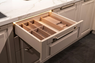 Wooden drawer organizer designed for efficient kitchen storage