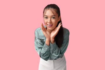 Wall Mural - Happy young Asian woman with stylish mint makeup on pink background