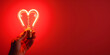 © Ekaterina - A vibrant red heart shaped light bulb glowing brightly in a hand, set against a deep red background, symbolizing love and passion