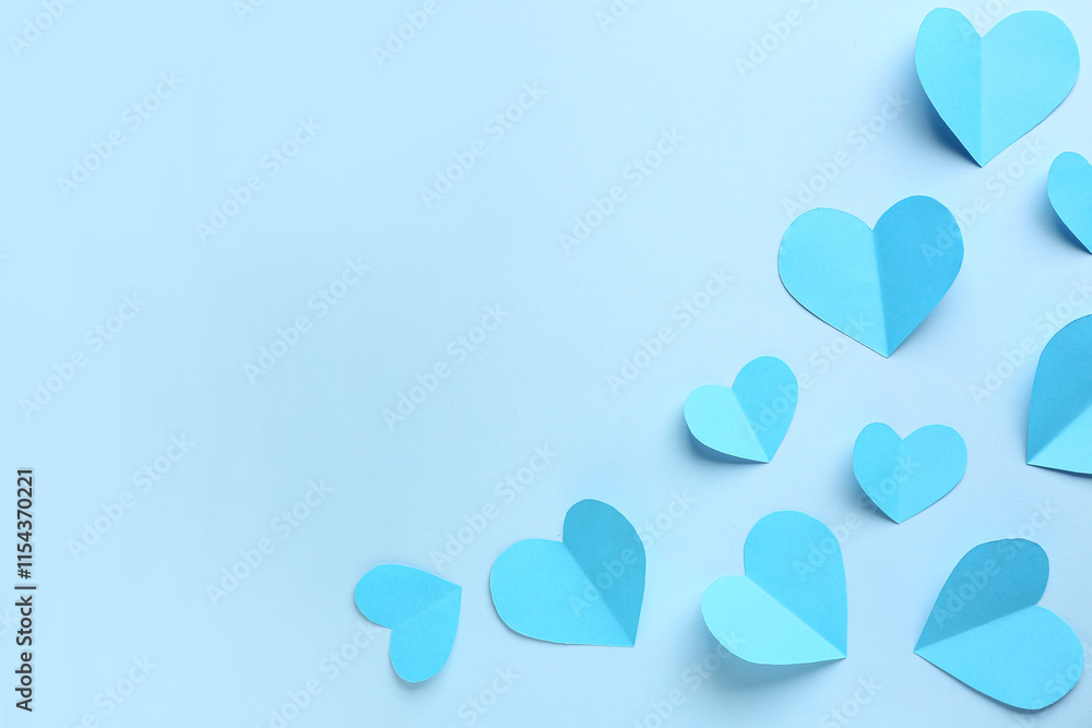 Blue paper hearts on color background. Valentine's Day celebration