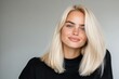 © Milos - A close-up of a smiling model with long, blonde hair wearing a black sweater, capturing a vibrant, joyful essence and a modern aesthetic. Perfect for fashion or lifestyle themes.