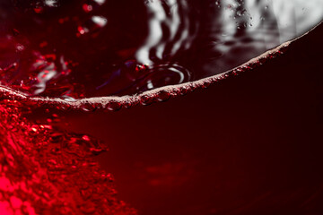 Wall Mural - Red wine abstract splashing in glass.