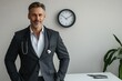 © hkjdesign - Confident male doctor in a suit, a stethoscope around his neck, stands in his office.