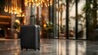 © Maximages  - An elegant suitcase stands in a luxurious hotel lobby on polished flooring, with warm lighting and leafy plants adding a touch of tranquility nearby.