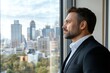 © Milos - A contemplative man gazes thoughtfully out a window, reflecting on the bustling city life below, embodying ambition and introspection against a stunning urban backdrop.
