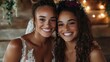 © JoxyAimages - Two radiant sisters at an intimate wedding ceremony, both in elegant white dresses adorned with floral headpieces, capturing a beautiful familial bond.